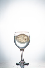 slice of lemon drops in a glass of water
