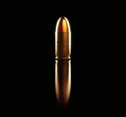 Single Warmly Lit Pistol Bullet on Black