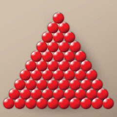 A lot of glossy red balls on a brown background. A pile of balls.