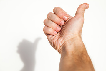 Male hand shows thumbs up gesture