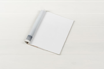 Mock-up magazine or catalog on white wooden table. Blank page or notepad on wood background. Blank page or notepad for mockups or simulations.