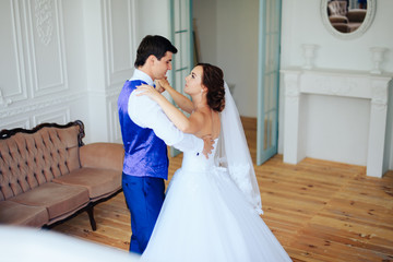 bride dancing with the groom in the room