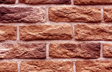 Red toned brick wall surface.