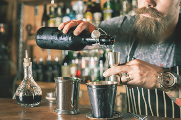 Handsome barman is making cocktail