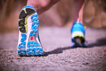 Running athlete during training outdoors in the summer on a sunny day.