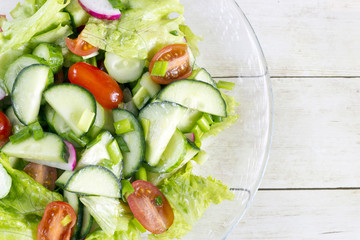 Homemade Vegetable salat on light wood background, top view