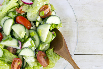 Homemade Vegetable salat on light wood background, top view