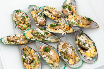 Tasty marinated Mussels with fresh herbs and cheese 