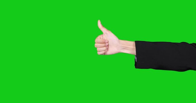 Businessman hand pointing and showing thumb up in the studio, shot with green screen background
