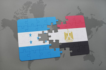 puzzle with the national flag of honduras and egypt on a world map