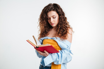 Pretty young casual woman reading book