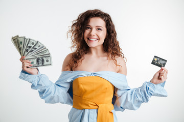 Beautiful young girl holding cash and credit card