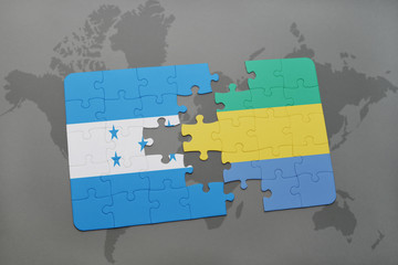puzzle with the national flag of honduras and gabon on a world map
