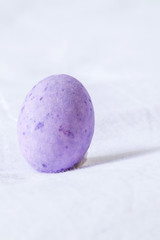Purple easter egg in a white sheet