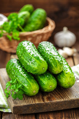 Fresh cucumbers on wooden background close up