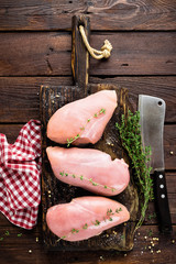 Raw chicken meat fillet on wooden background top view