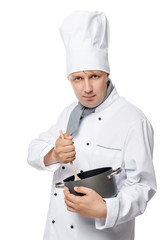 serious experienced cook mixing with a wooden spoon food in a pot on a white background