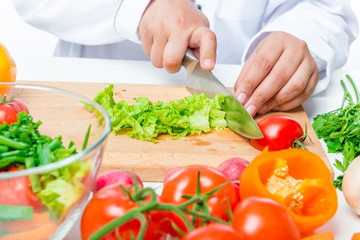 green juicy salad sliced on a wooden cutting board close up