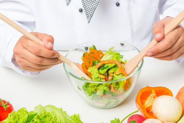 Obraz na płótnie Canvas close up chopped vegetables in a glass bowl, chef salad mixes