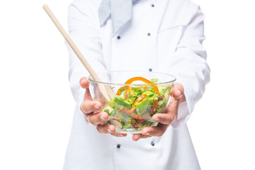 fresh tasty salad in the bowl holding a professional chef, salad closeup