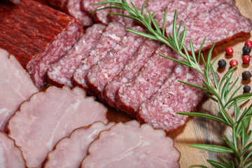 Set of cold cuts on a wooden board. Mix of sausages