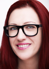 Beautiful young woman wearing glasses close-up isolated on white background.