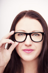 Beautiful young woman wearing glasses close-up isolated on white background.