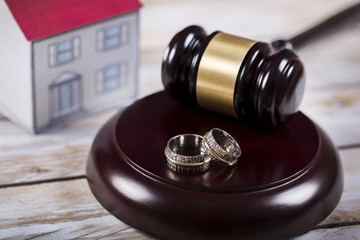 Family law concept. Divorce. Gavel, house and rings