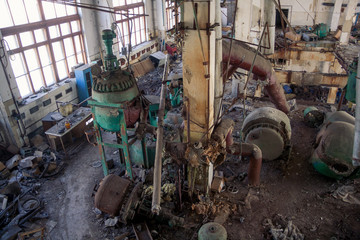 Fototapeta premium The abandoned chemical pharmacy vitamin plant with the remains of equipment
