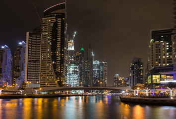 Fototapeta na wymiar Skyscrapers in Dubai Marina at night. United Arab Emirates