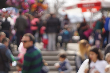 Out of focus, unrecognizable people walking in the park