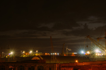 View to old docks and port cranes in night, Senglea