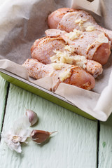 Uncooked poultry thigh on paper