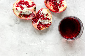 ripe pomergranate and glass of juice on table background top view mock-up