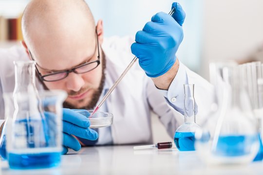 Man researcher carrying out scientific research.