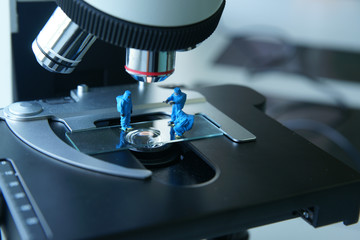 Miniature people scientist At Work