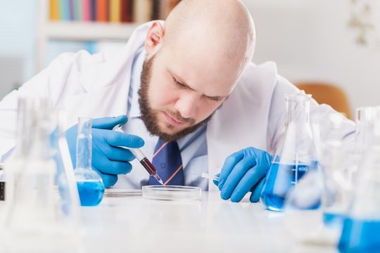 Man researcher carrying out scientific research.