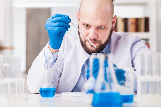 Man researcher carrying out scientific research.