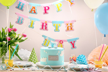 Birthday party with blue cake and balloons