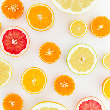 Fruit's background. Pattern of lemon, orange, grapefruit, sweetie and pomelo on white background. Flat lay, top view.