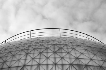 Fototapeta premium Monochrome black and white photo of elements modern building. Dome trimmed with triangular aluminum panels. Abstract bark background
