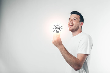 isolated on white background man in white shirt holding a lamp. Concept idea.