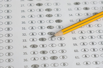 A pencil sitting on a test bubble sheet, optical form of an examination,Answer sheet with...