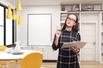 Geek girl with a book in a room with poster