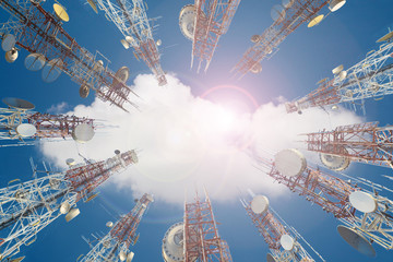 Mobile phone communication antenna tower with cloud on center blue sky.