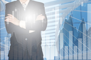 Double exposure of businessman arms crossed and stand up with cityscape and financial graph background