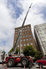 Moving into a high rise apartment building urban style with telescopic crane.