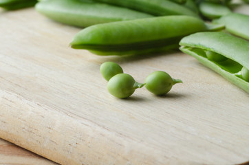 Green Peas and Pods on Wooden Chopping Board