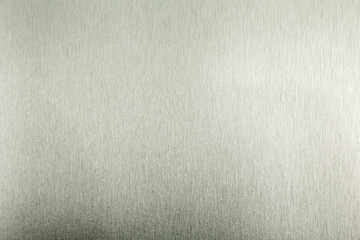 Stainless steel metal surface background or aluminum brushed silver texture with reflection.