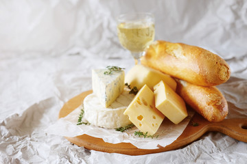 Cheese plate with different kinds of cheese with white wine